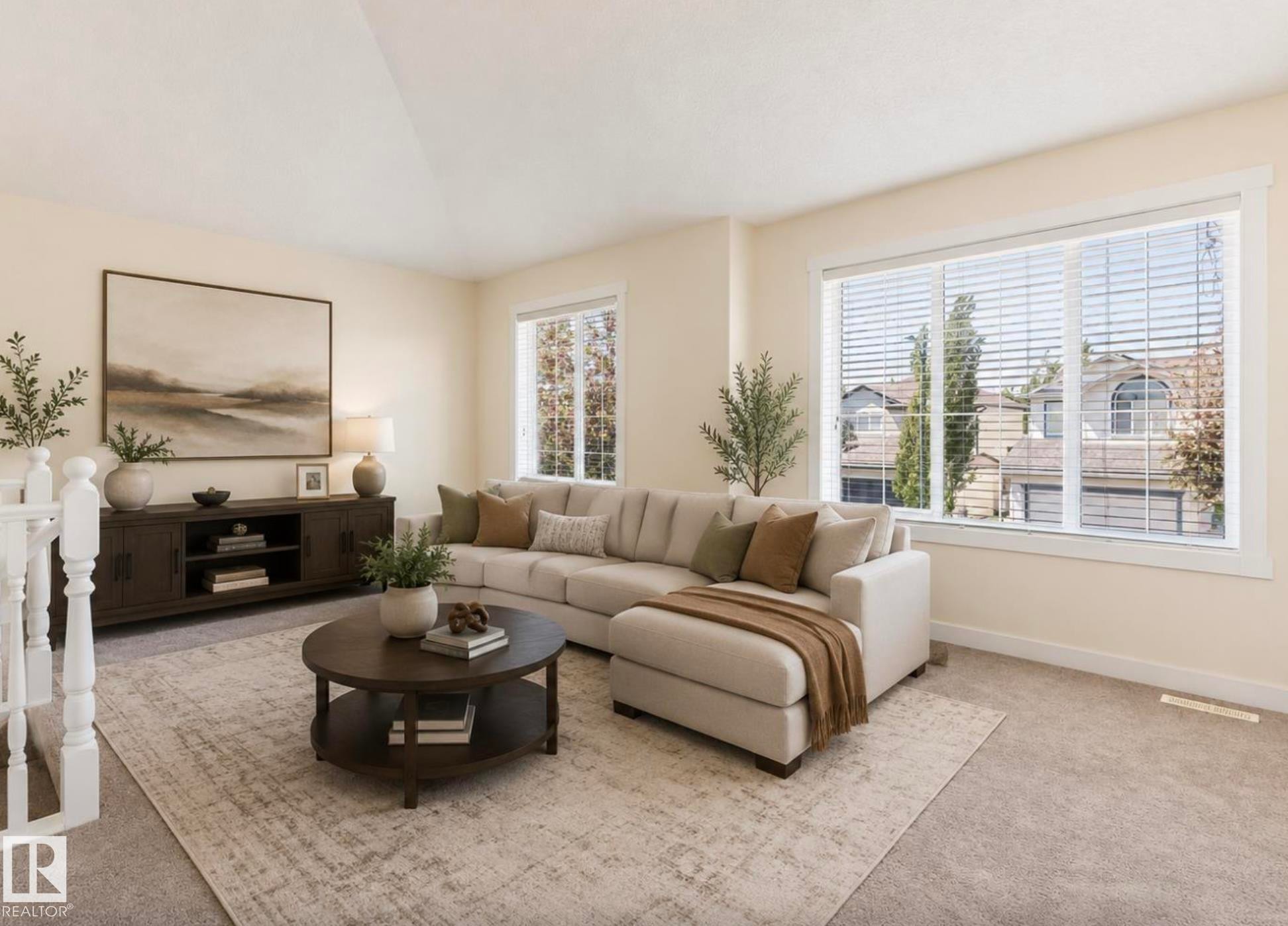 Bright living area featuring neutral-toned walls, expansive windows with white blinds, and soft carpeting - 1007 Macewan Close Sw, Edmonton, AB - Indoor Photo Showing Living Room