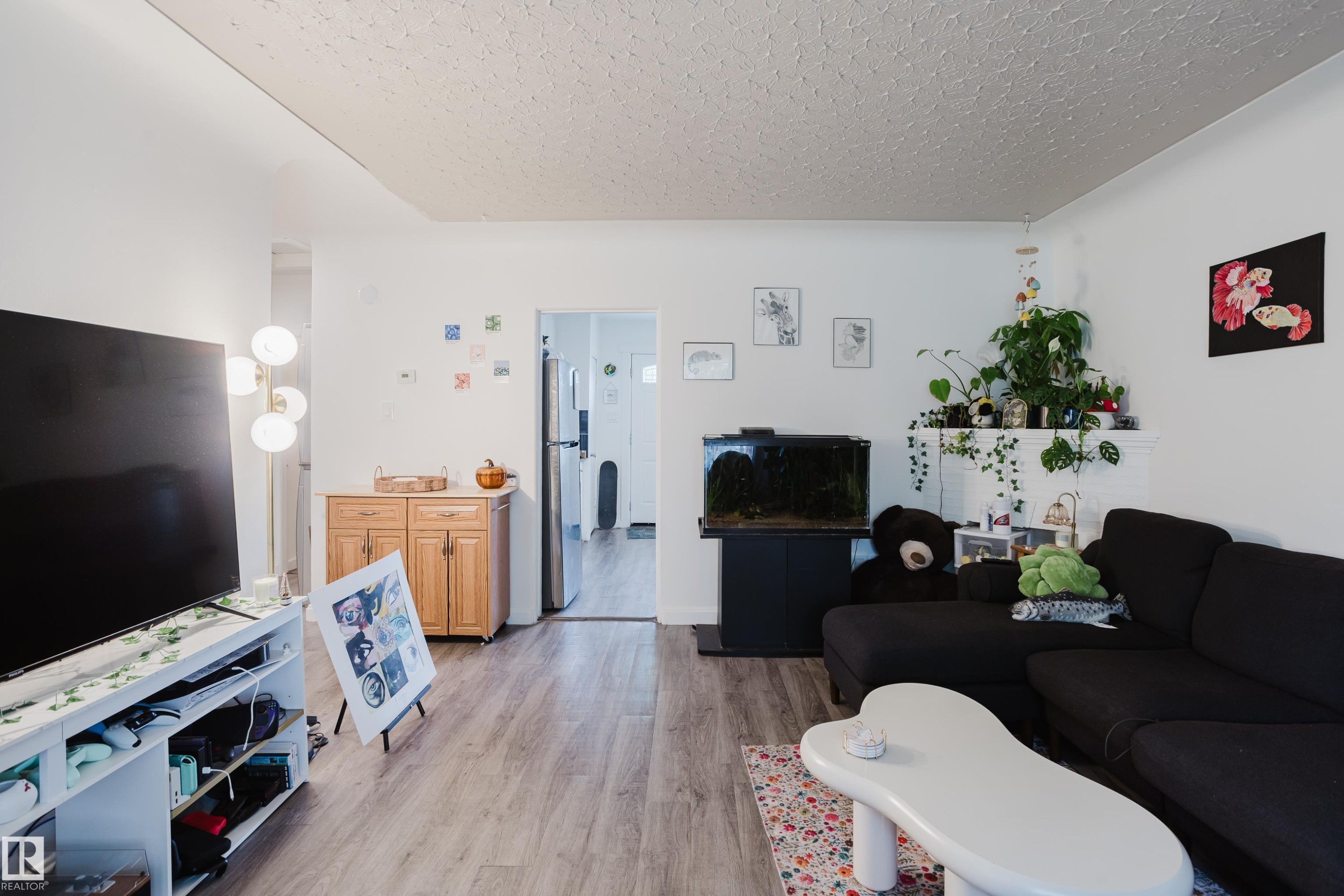 Light wood-finish flooring, white walls, and a recessed doorway - 11134 11138 116 Street Nw, Edmonton, AB