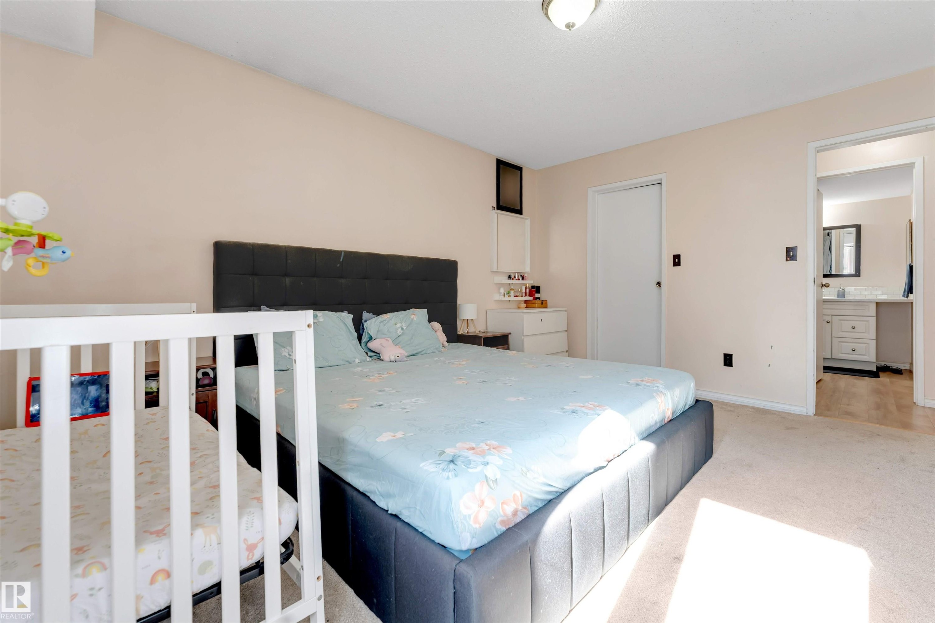 Neutral-toned walls, overhead light fixture, carpeted flooring, and a white interior door - #101 49 Akins Dr, St. Albert, AB