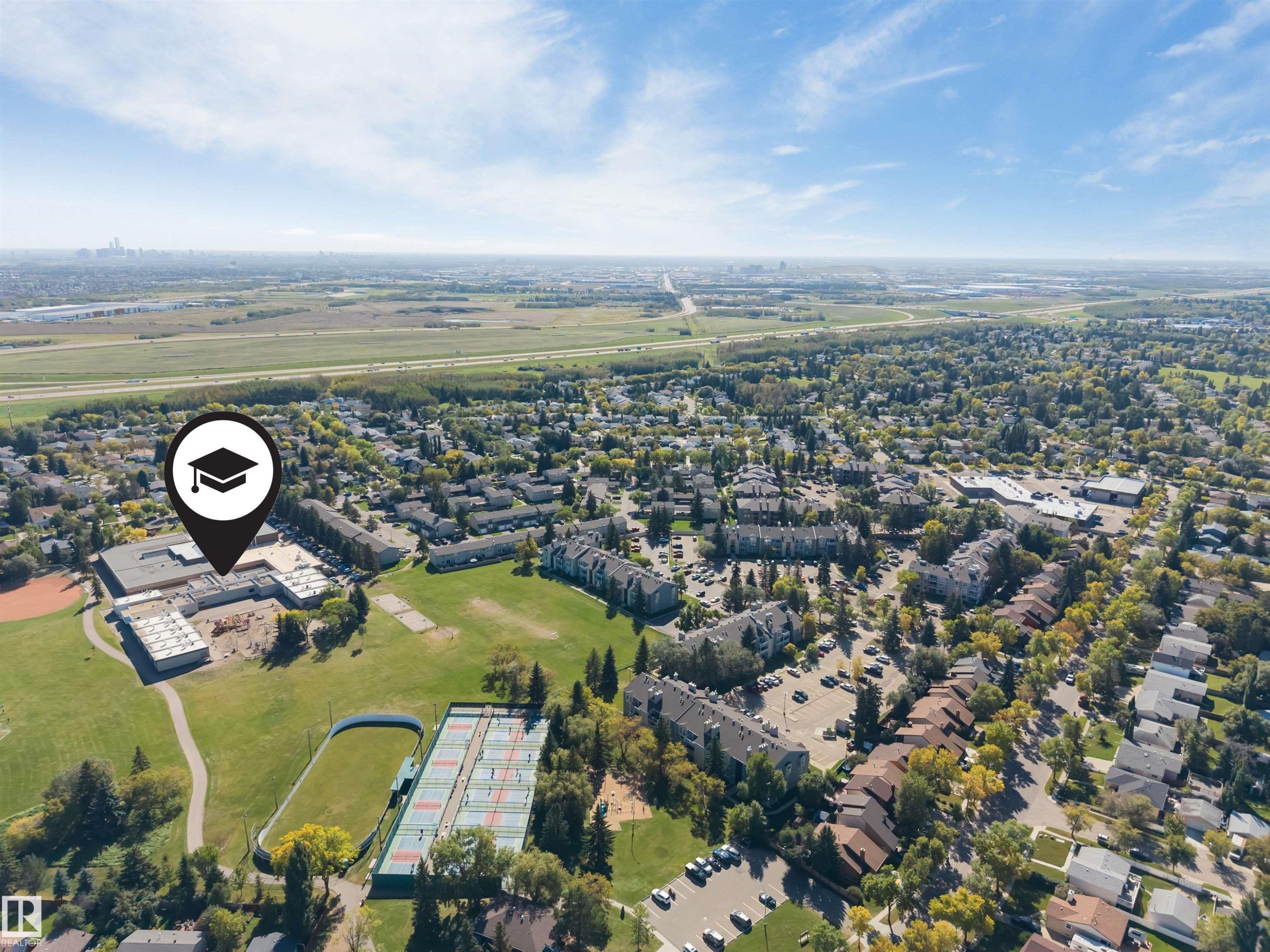 Aerial perspective showcasing a developed suburban area with extensive tree coverage - #101 49 Akins Dr, St. Albert, AB