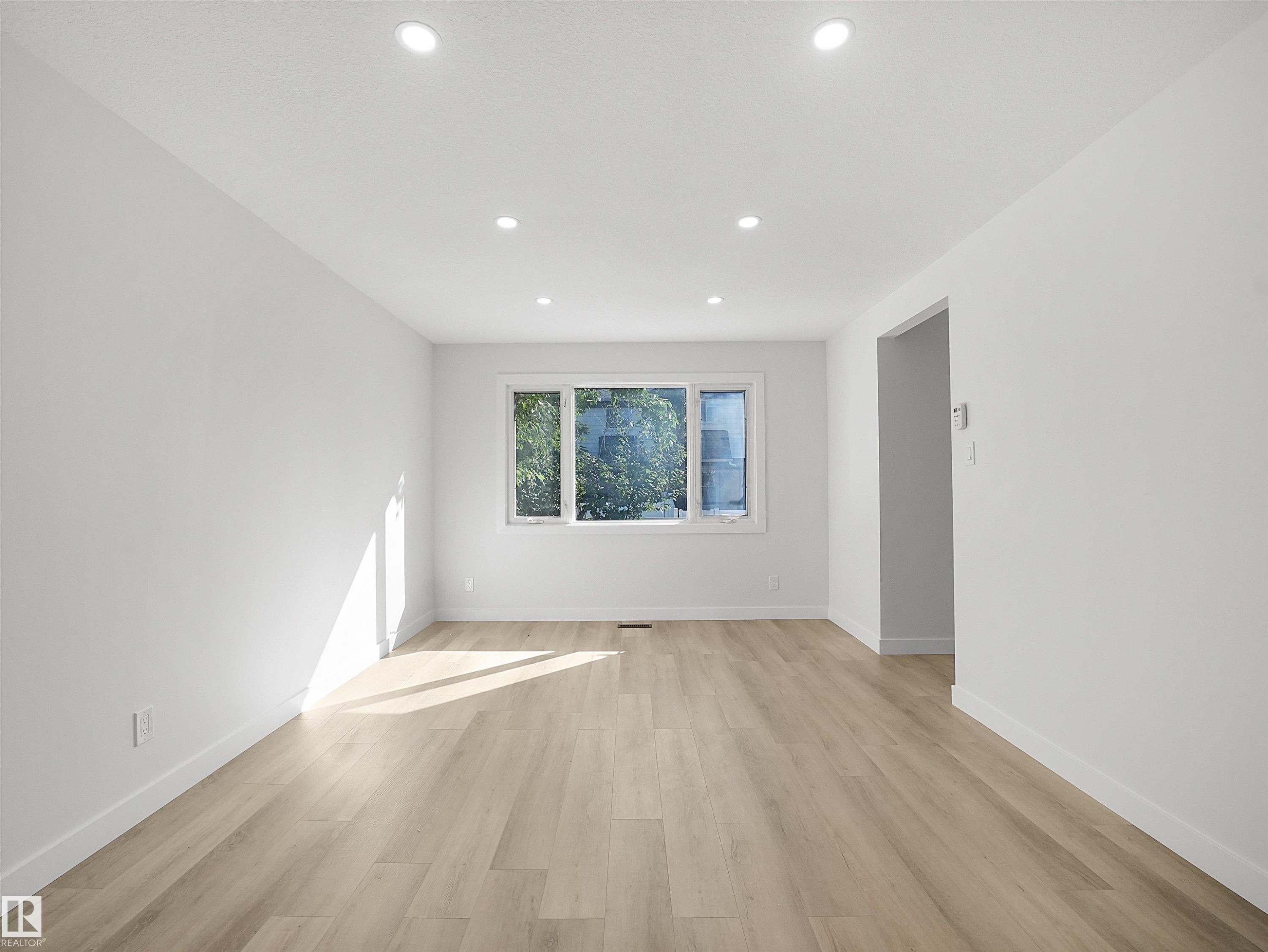 Recessed ceiling lighting, light wood-finish flooring, white painted walls, and a multi-pane window - 12C Twin Terrace Nw, Edmonton, AB