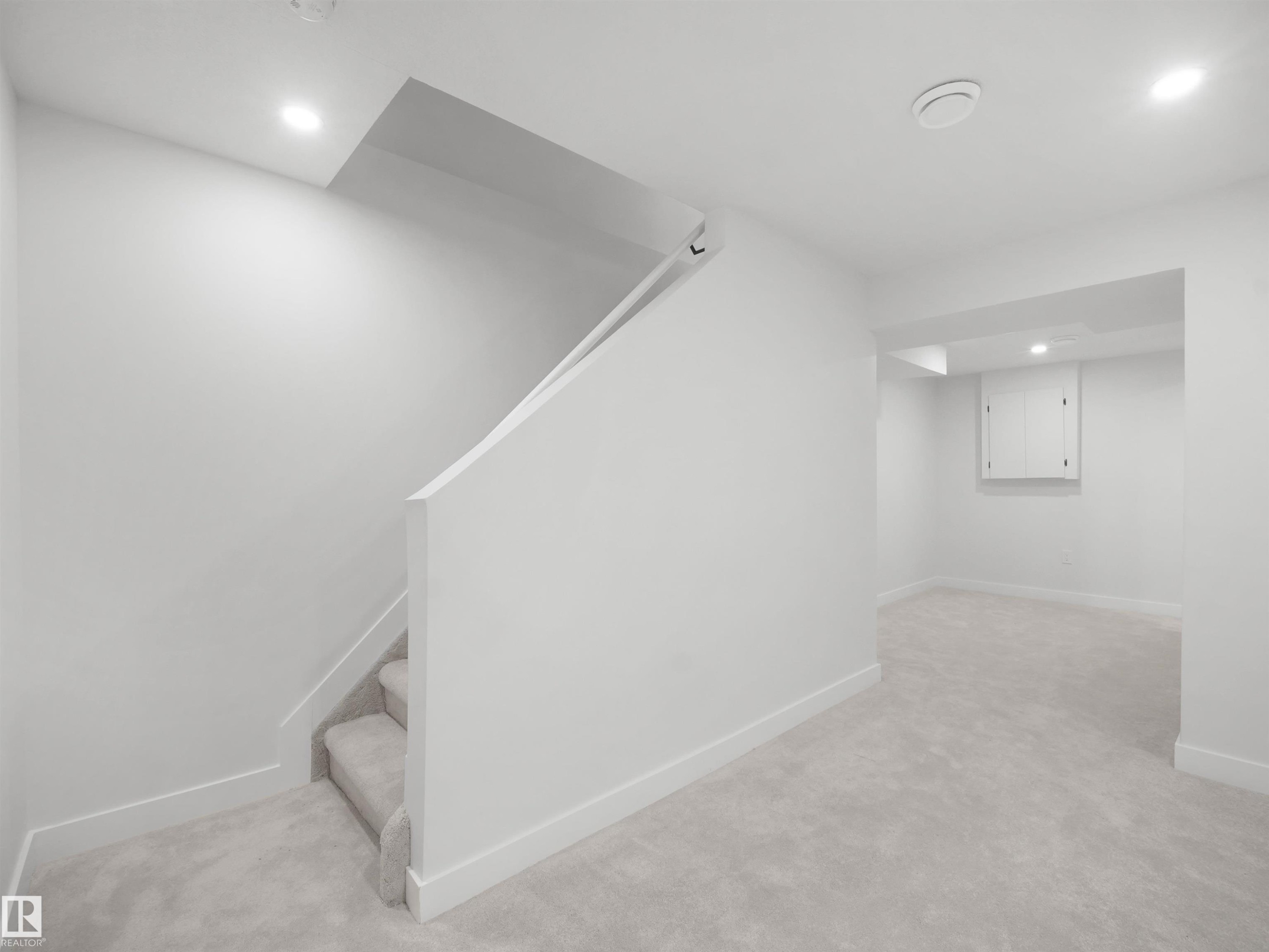 Carpeted staircase with recessed lighting, leading to a spacious carpeted area - 12C Twin Terrace Nw, Edmonton, AB