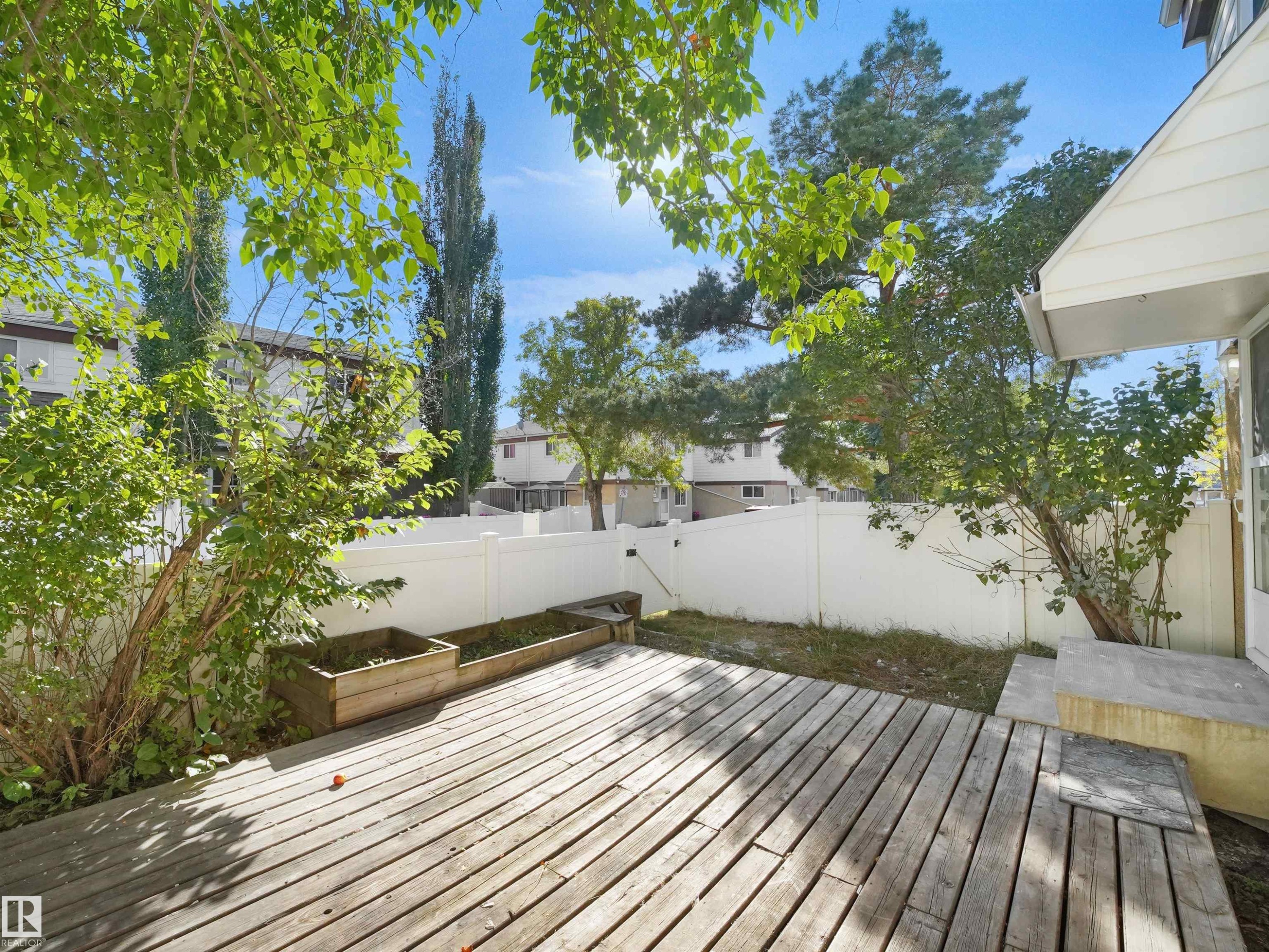Outdoor wood-finish deck with privacy fencing - 12C Twin Terrace Nw, Edmonton, AB