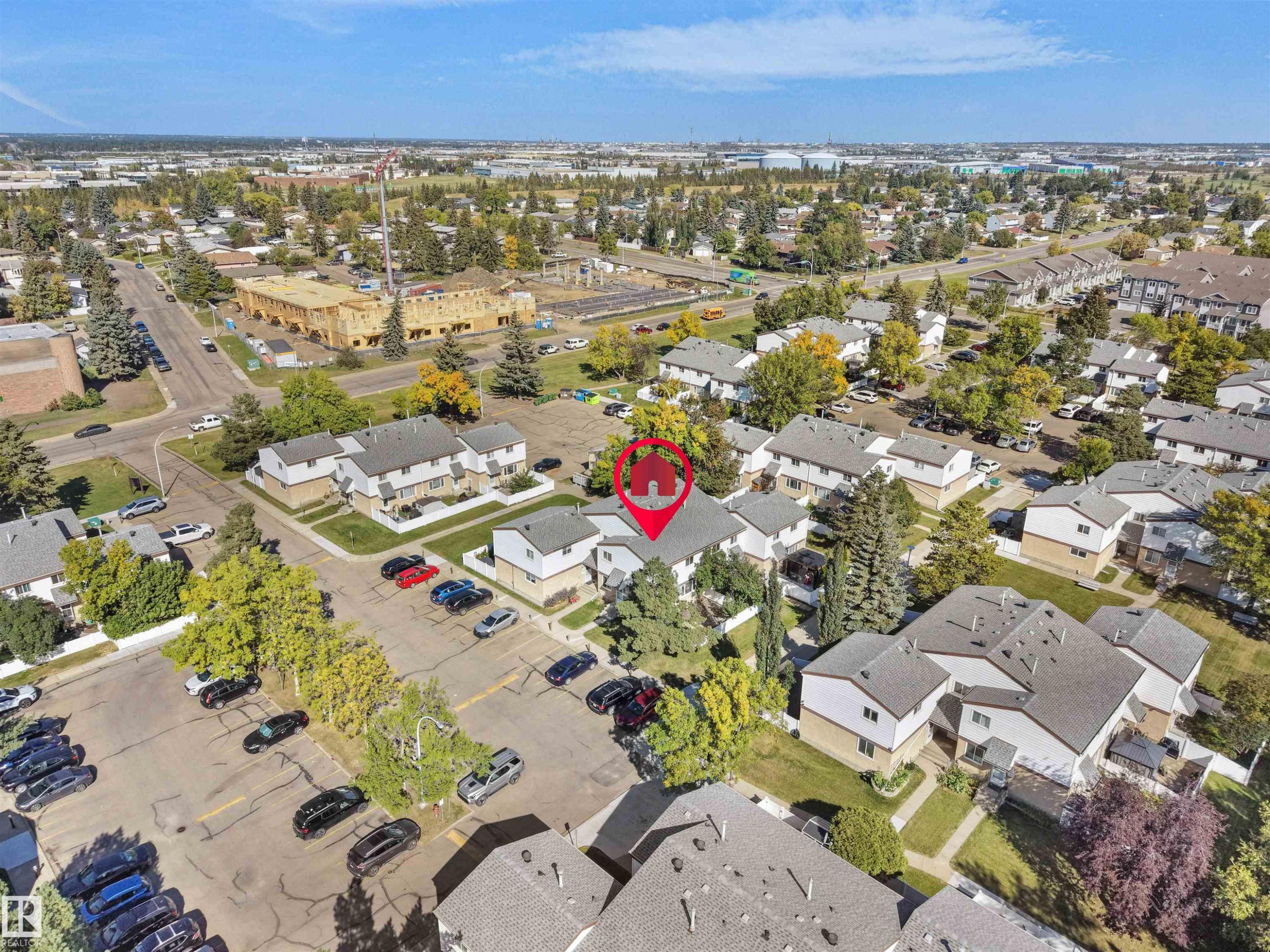 Residential neighborhood featuring multiple buildings with gabled roofs and visible parking areas - 12C Twin Terrace Nw, Edmonton, AB