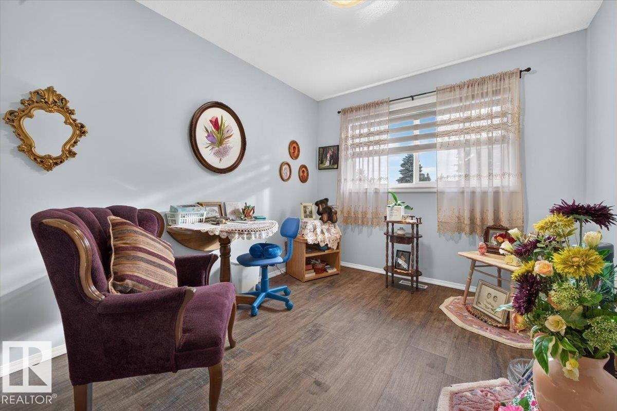 Wood-finish flooring with light blue wall paint - #125 4610 50 Ave, Stony Plain, AB
