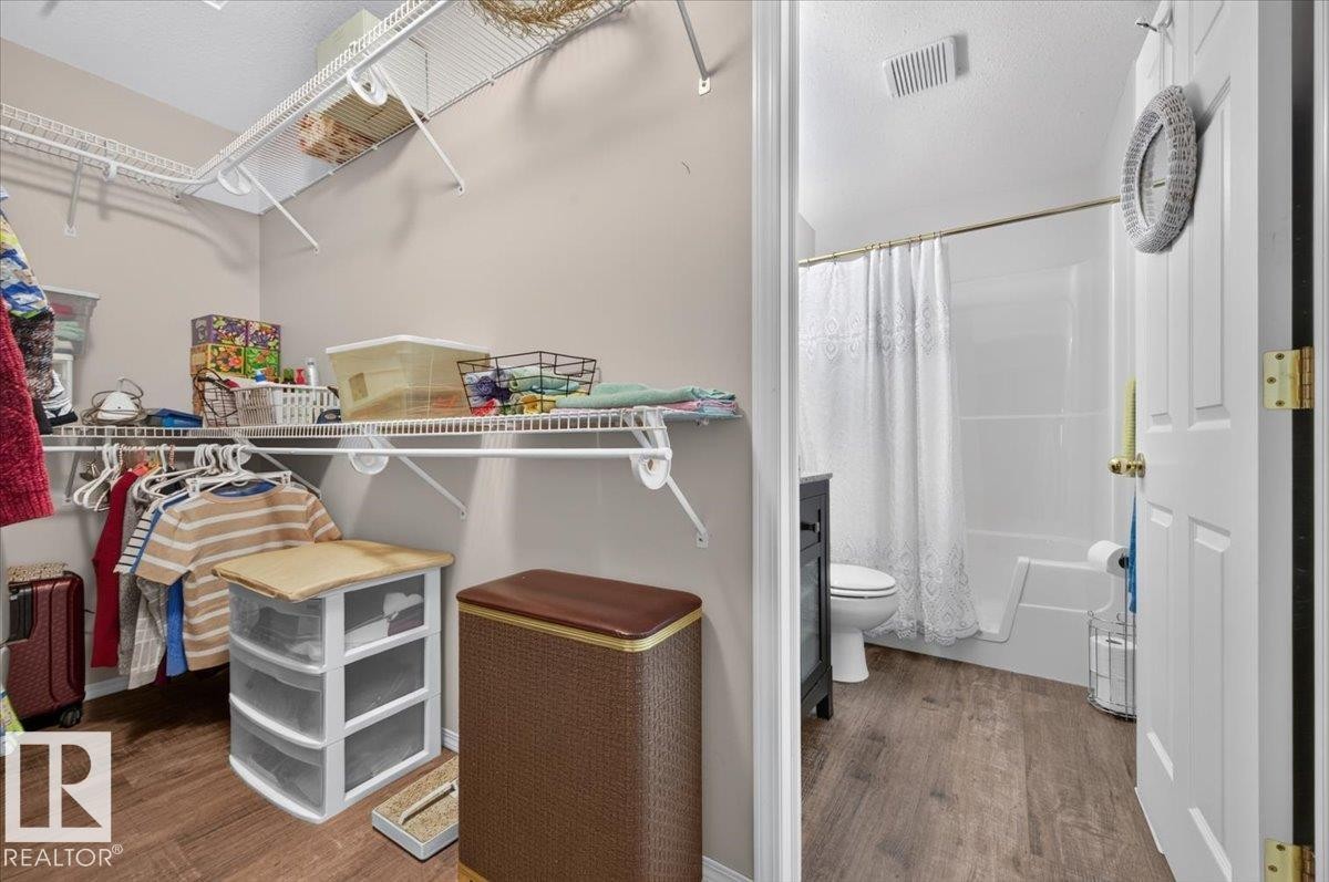 Walk-in closet with wire shelving and wood-finish flooring - #125 4610 50 Ave, Stony Plain, AB