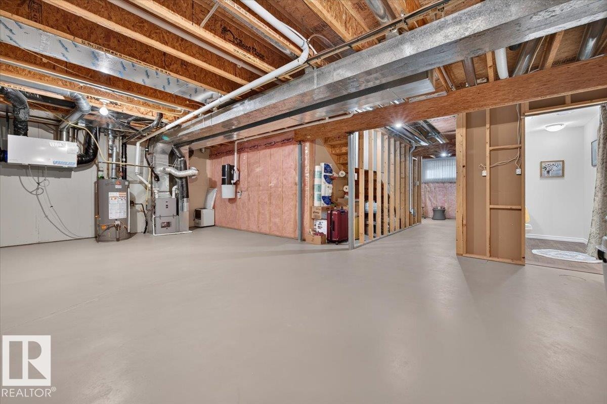 Unfinished basement with open framing and exposed ceiling joists - #125 4610 50 Ave, Stony Plain, AB