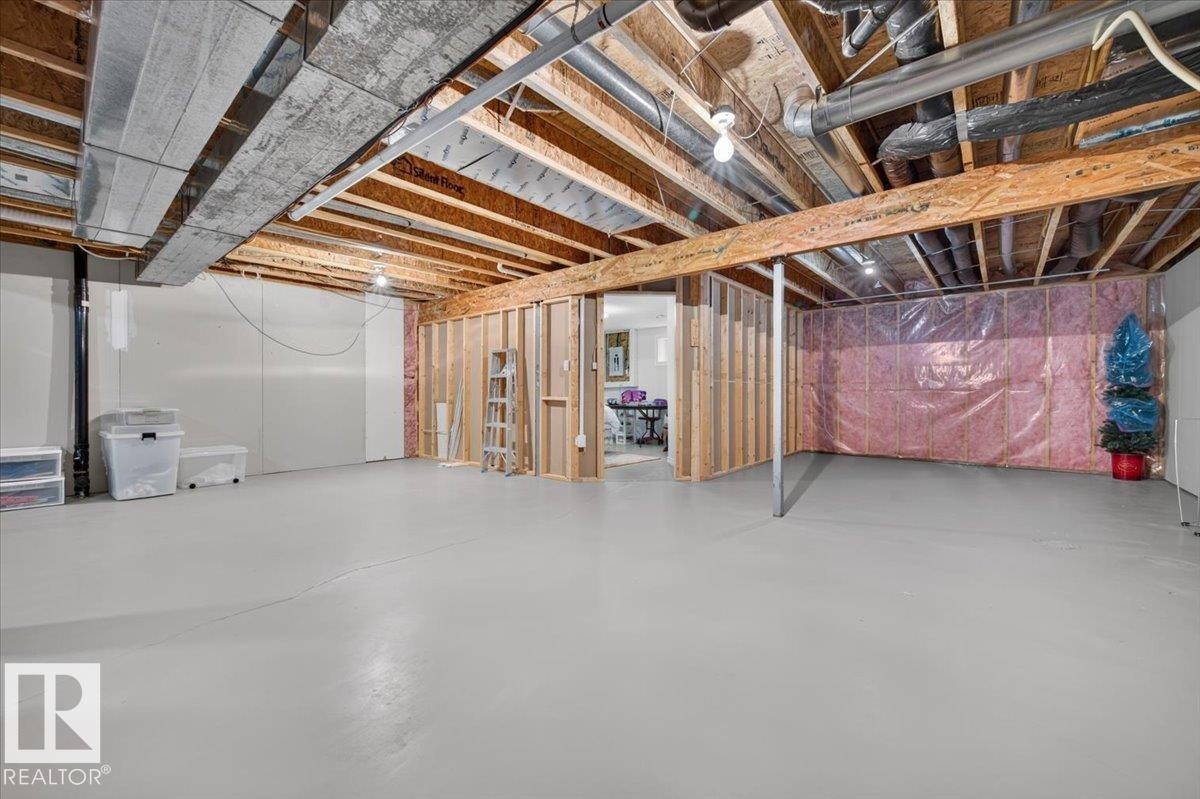 Unfinished basement space featuring exposed wood joists and concrete flooring - #125 4610 50 Ave, Stony Plain, AB