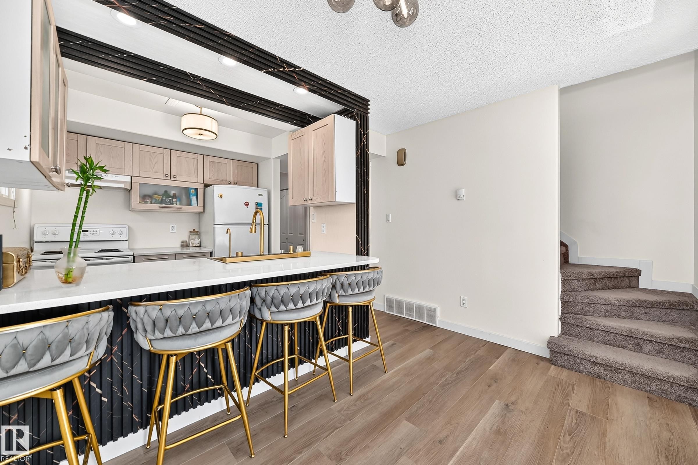 Kitchen featuring wood-finish flooring, white countertops, and light wood cabinetry - 161 Lancaster Terrace Nw, Edmonton, AB
