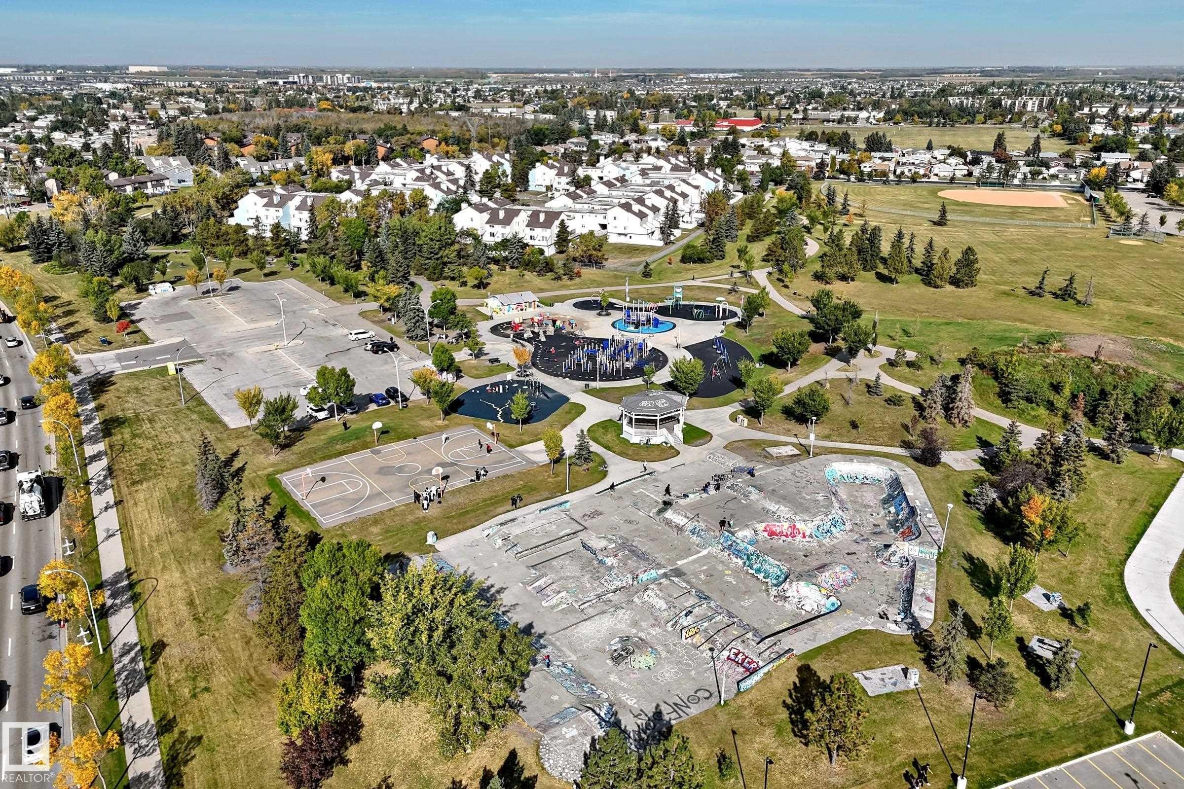 Expansive green space featuring a skatepark, basketball courts, and paved pathways - 161 Lancaster Terrace Nw, Edmonton, AB