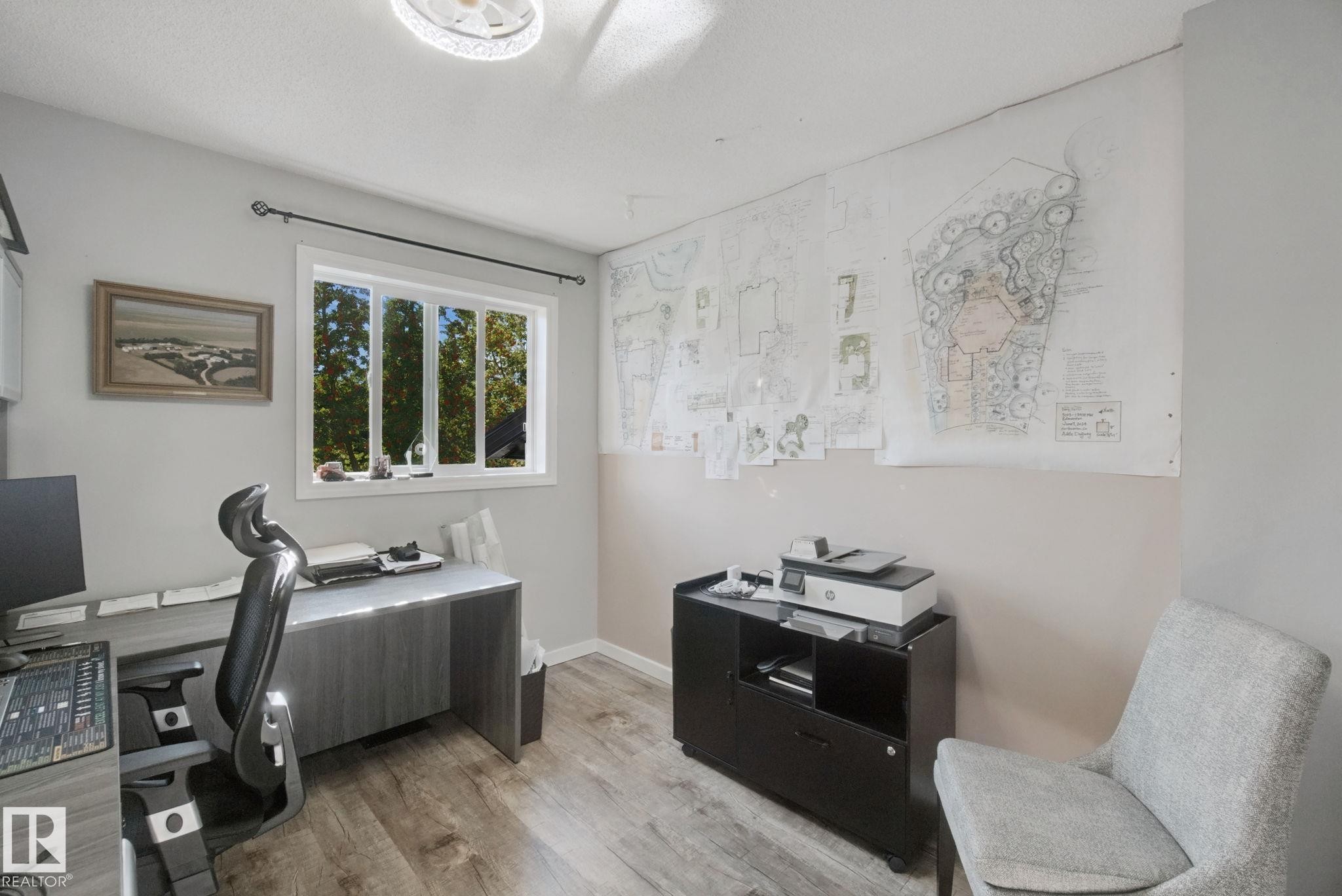 Wood-finish flooring, white trim window, neutral wall paint, and overhead lighting - 38 Menalta Place, Cardiff, AB