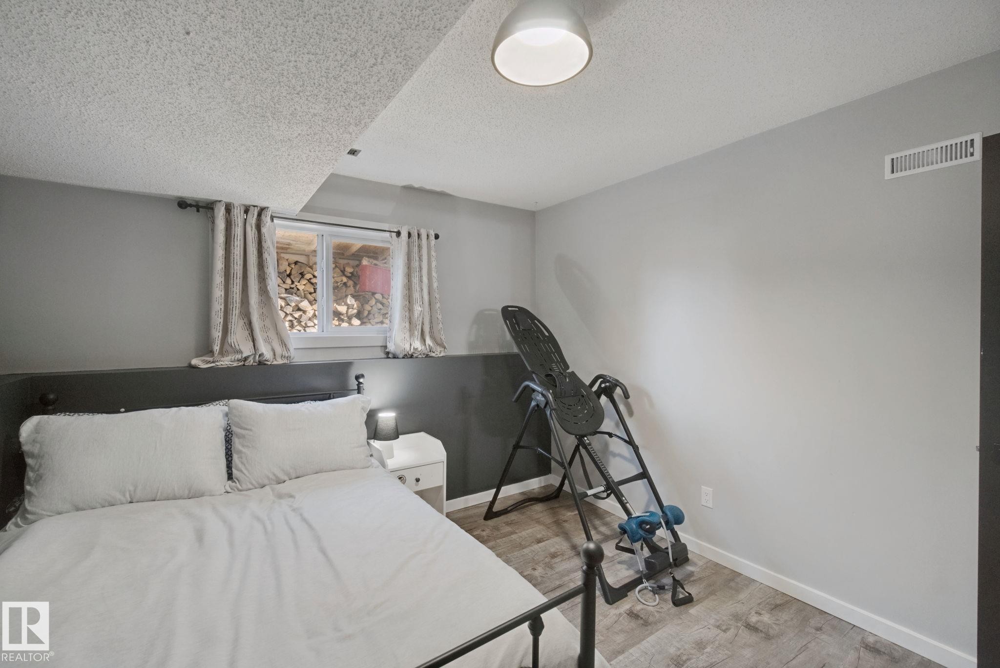 Wood-finish flooring with white trim and a neutral color palette - 38 Menalta Place, Cardiff, AB