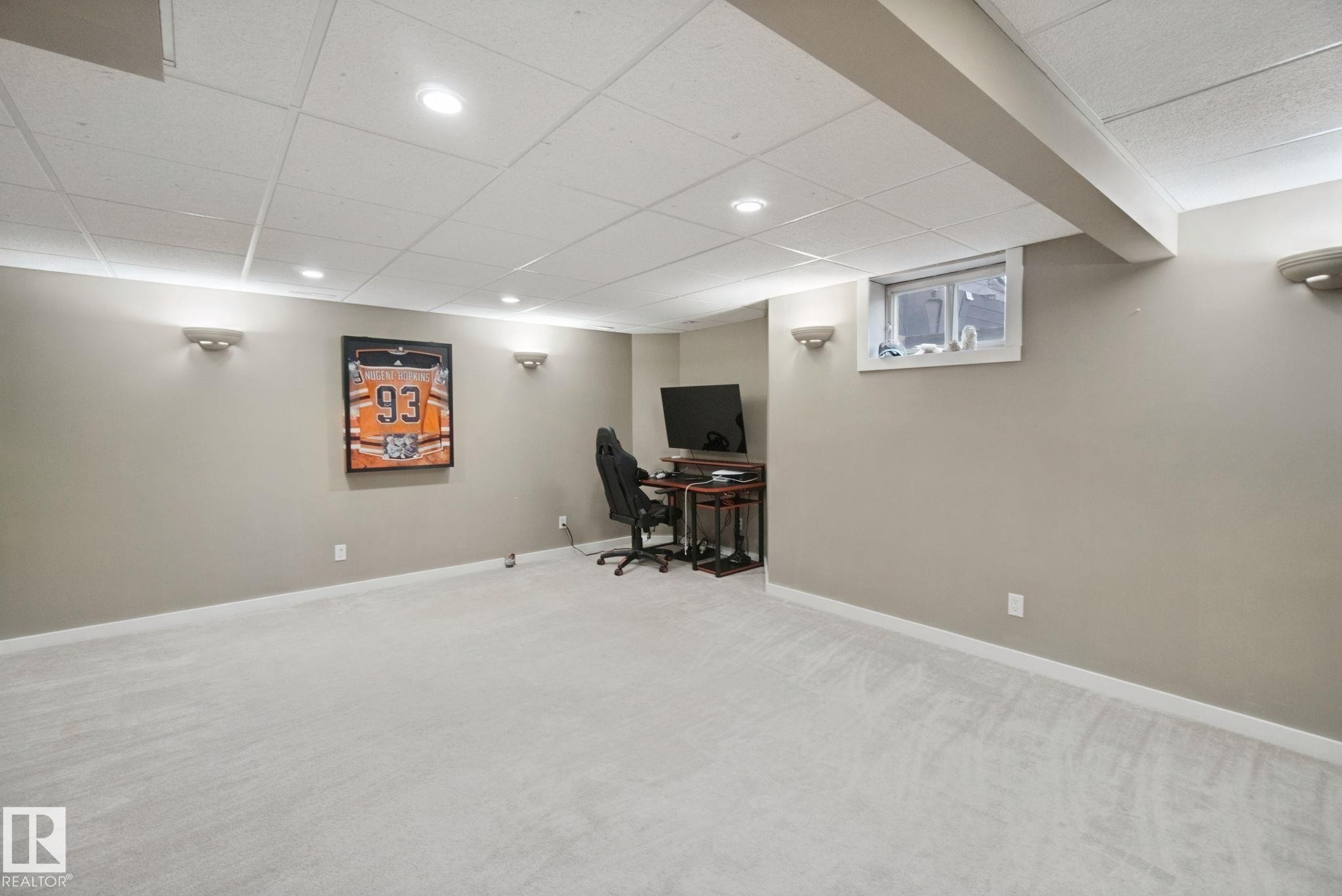 Recessed lighting, wall sconces, drop ceiling, light-colored carpeting, and a window - 38 Menalta Place, Cardiff, AB