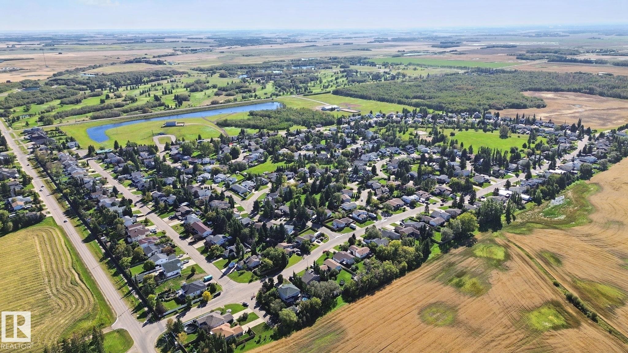 Aerial perspective showcasing residential properties within a developed neighborhood - 38 Menalta Place, Cardiff, AB