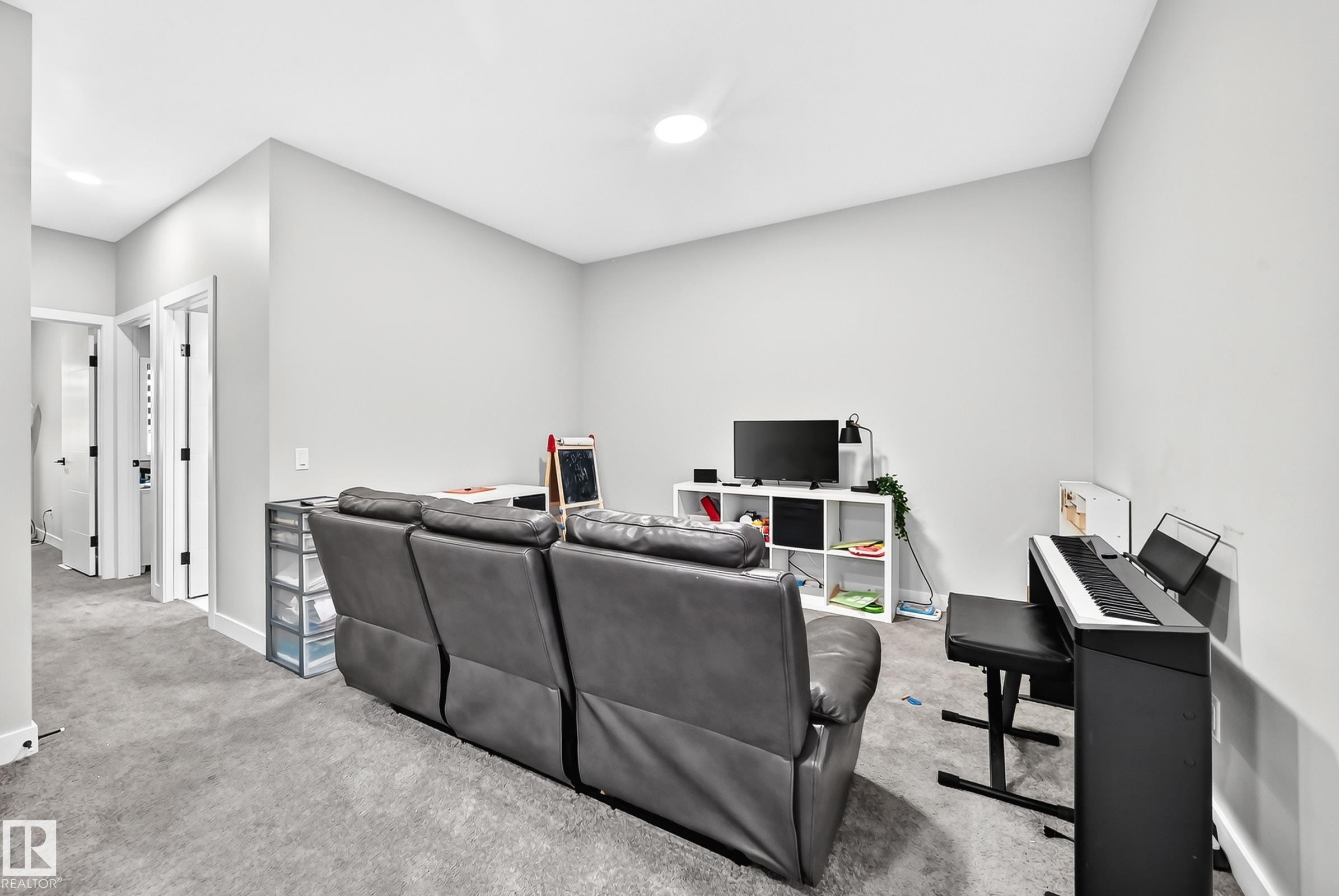 Carpeted room with light gray walls, an overhead recessed light, and white trim - 2415 194 Street Nw, Edmonton, AB