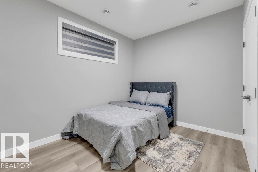 Recessed lighting, wood-finish flooring, and a horizontal window with blinds - 2415 194 Street Nw, Edmonton, AB