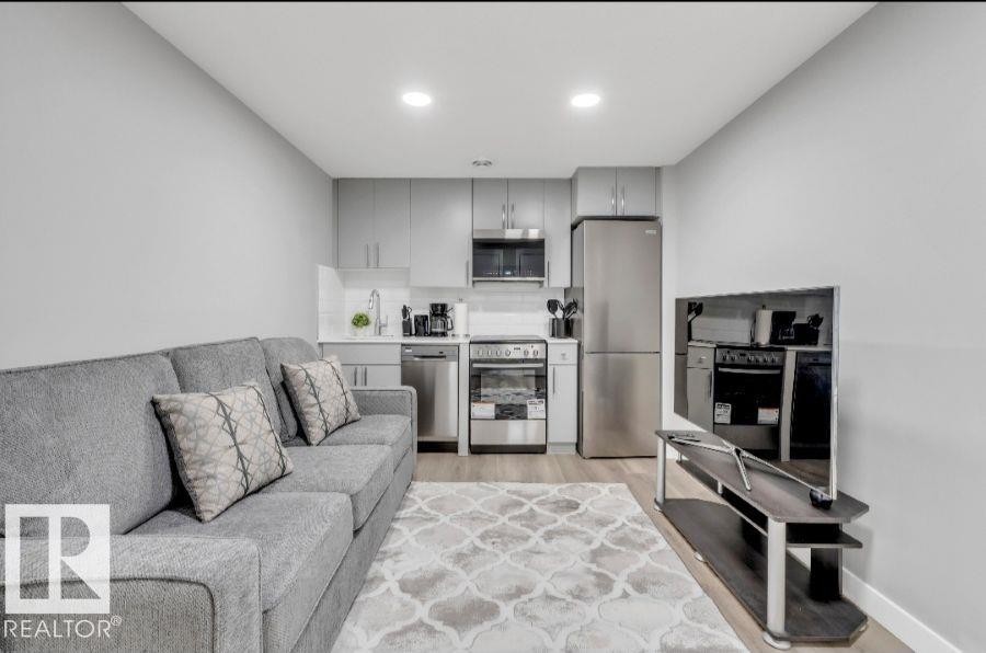 Compact kitchen with stainless steel appliances, light gray cabinetry, and white countertops - 2415 194 Street Nw, Edmonton, AB