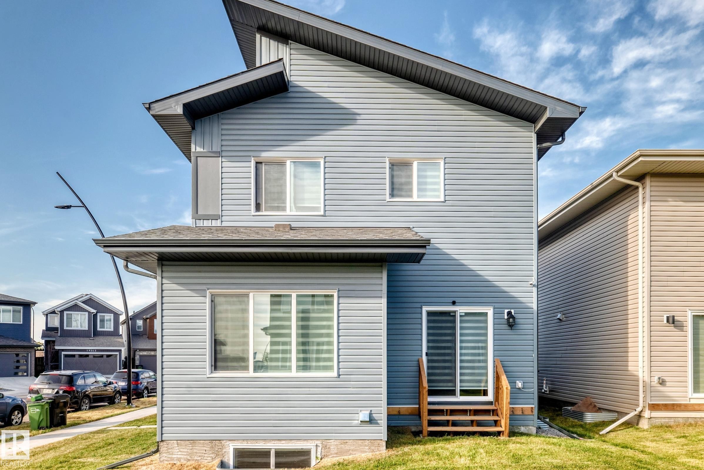 Multi-level property exterior with light blue horizontal siding - 2415 194 Street Nw, Edmonton, AB