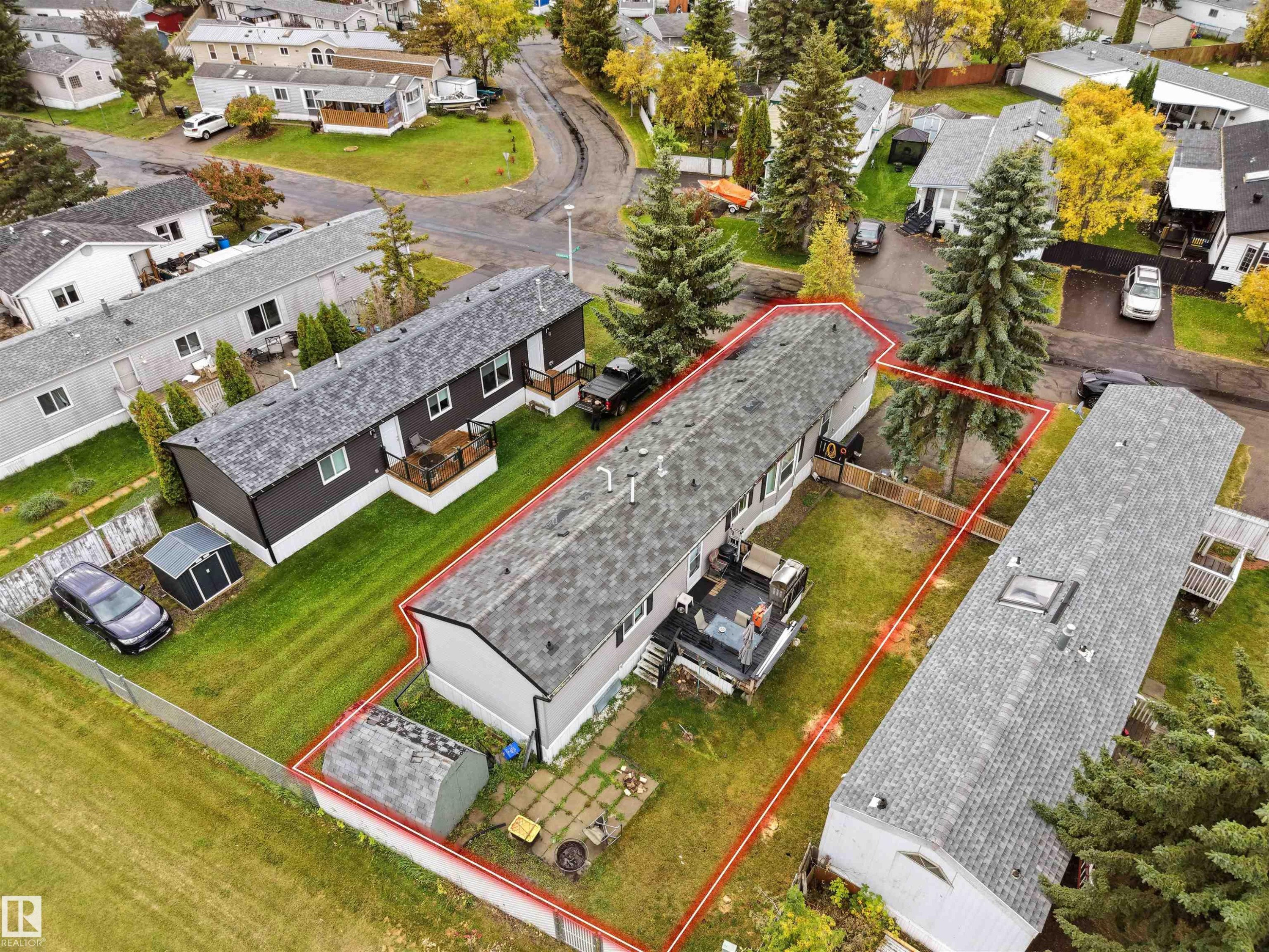 Expansive property featuring a fenced yard, two outdoor decks, a storage shed, and mature trees - 52 Evergreen Park Northwest, Edmonton, AB