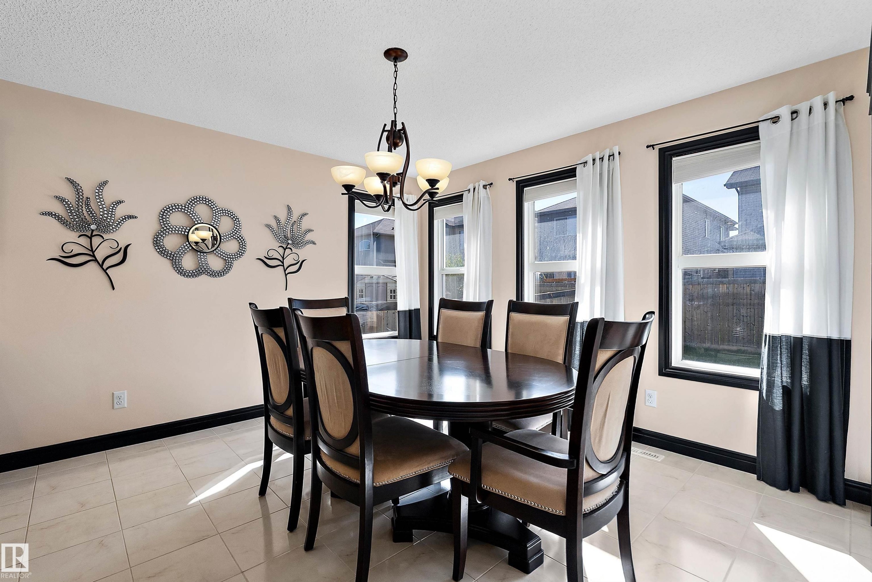 Recessed lighting, tiled flooring, multiple windows with dark trim, and a chandelier with glass shades - 11515 16 Avenue Sw, Edmonton, AB