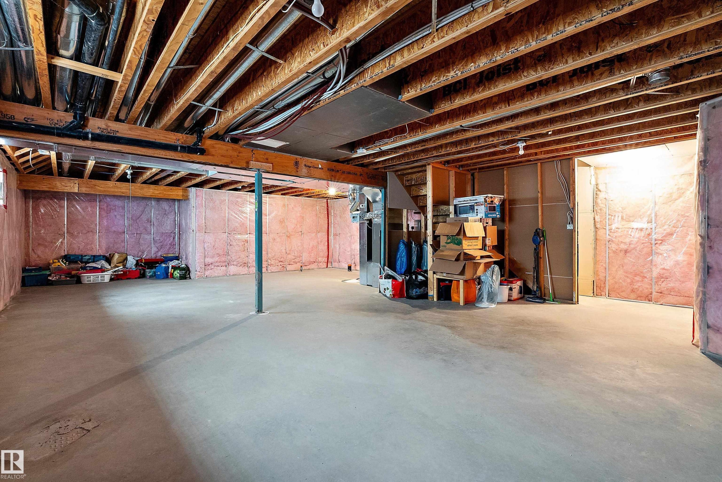 Unfinished basement featuring exposed wood joists and concrete flooring - 11515 16 Avenue Sw, Edmonton, AB