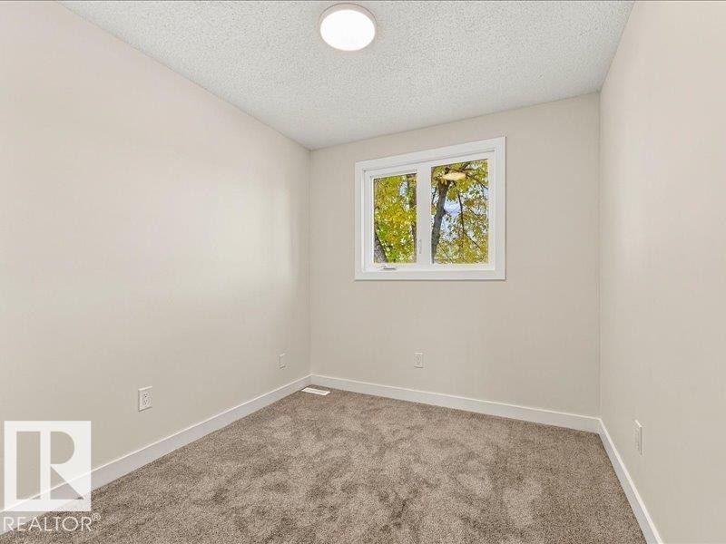 Neutral wall paint, plush carpeting, white trim, and a white window frame - 18325 66 Avenue Nw, Edmonton, AB