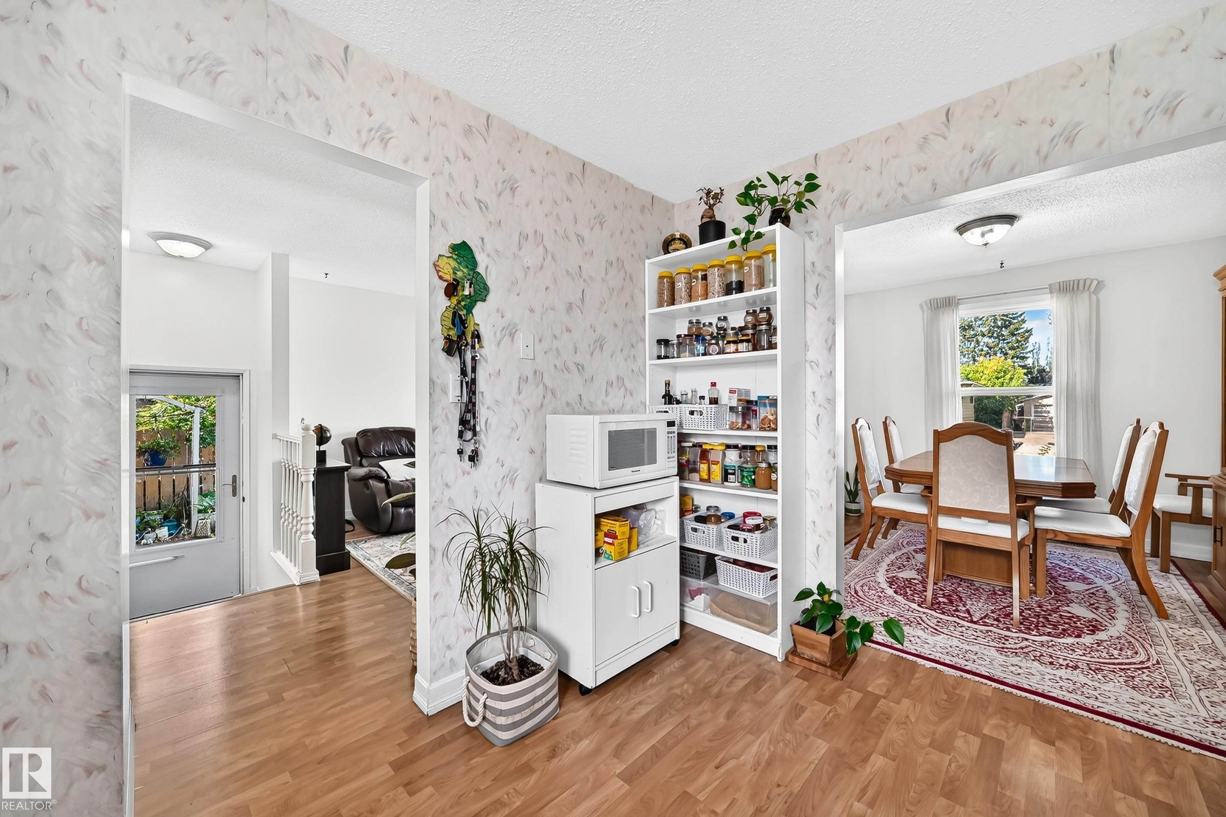 Wood-finish flooring, white trim work, and a ceiling-mounted light fixture - 11007 173A Avenue Nw, Edmonton, AB