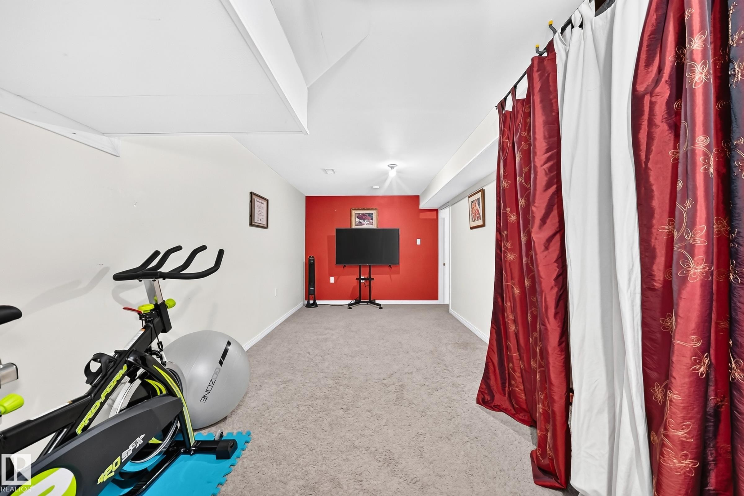 Carpeted flooring, recessed lighting, white walls, a red accent wall, and a white ceiling - 11007 173A Avenue Nw, Edmonton, AB