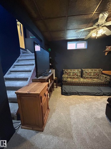 Carpeted flooring and stairs, with a drop ceiling featuring recessed lighting - 10678 Beaumaris Road Nw, Edmonton, AB 