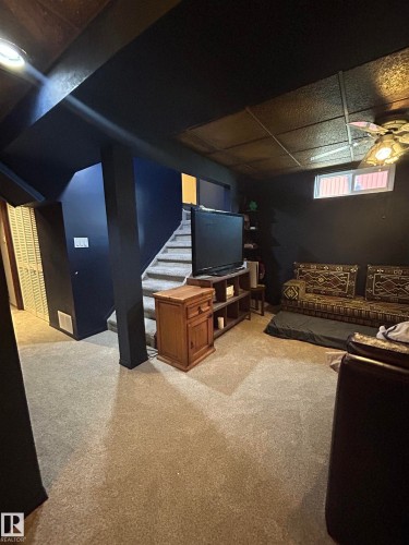 Carpeted flooring, painted walls, and a suspended ceiling with recessed lighting - 10678 Beaumaris Road Nw, Edmonton, AB 