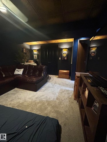 Wall-mounted sconce lighting, ceiling fan, and carpet flooring - 10678 Beaumaris Road Nw, Edmonton, AB 