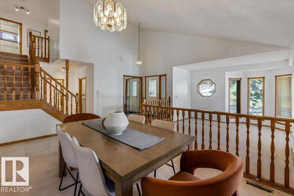 Vaulted ceilings, a chandelier, wood-finish staircase, and natural light from multiple windows - 507 Burton Close Nw, Edmonton, AB