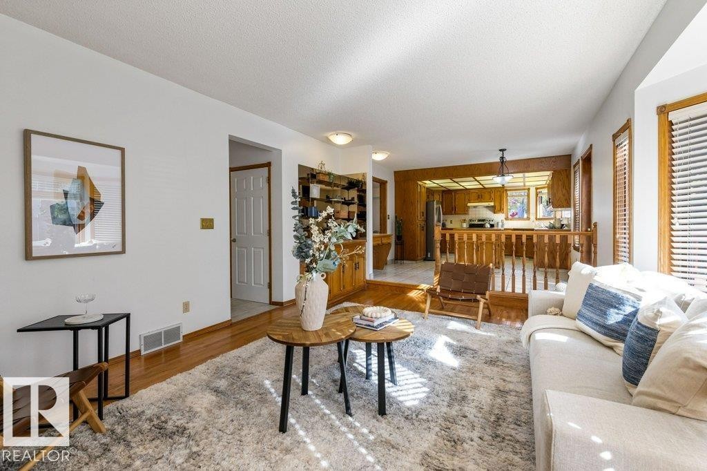 Hardwood-finish flooring, and a bay window - 507 Burton Close Nw, Edmonton, AB