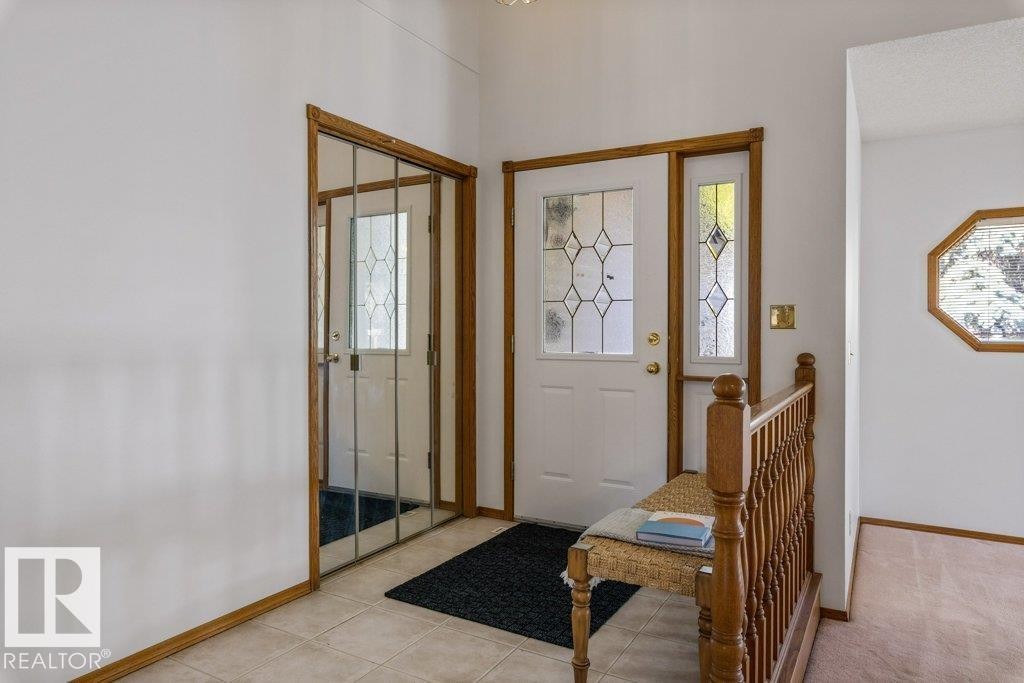 Tiled entryway with wood trim accents - 507 Burton Close Nw, Edmonton, AB