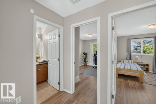 Wood-finish flooring throughout, white interior doors, and neutral wall paint - #41 287 Macewan Rd Sw, Edmonton, AB 