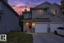 Two-story residence with light-toned siding and a prominent red entry door - #41 287 Macewan Rd Sw, Edmonton, AB 
