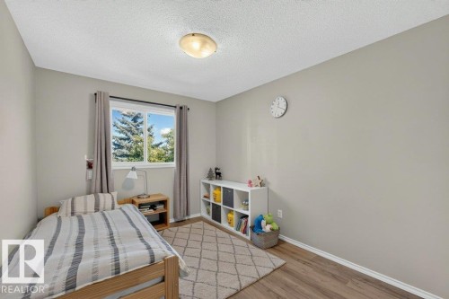 Wood-finish flooring, light grey painted walls, white trim, and a ceiling-mounted light fixture - #41 287 Macewan Rd Sw, Edmonton, AB 