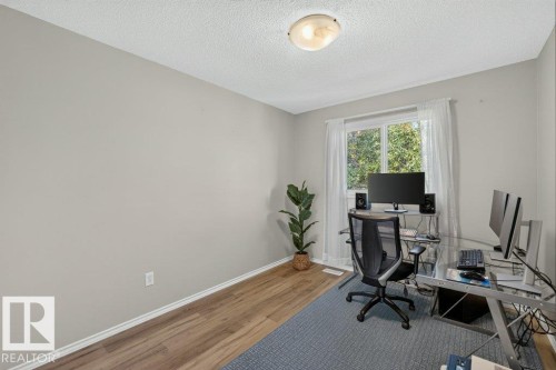 Wood-finish flooring, neutral wall tones, and a window with natural light - #41 287 Macewan Rd Sw, Edmonton, AB 