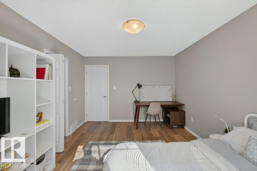 Wood-finish flooring, neutral wall paint, and white trim - #41 287 Macewan Rd Sw, Edmonton, AB 