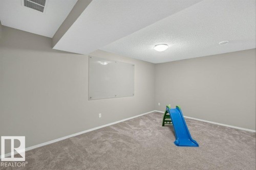 Carpeted flooring, recessed lighting, and a neutral wall color - #41 287 Macewan Rd Sw, Edmonton, AB 