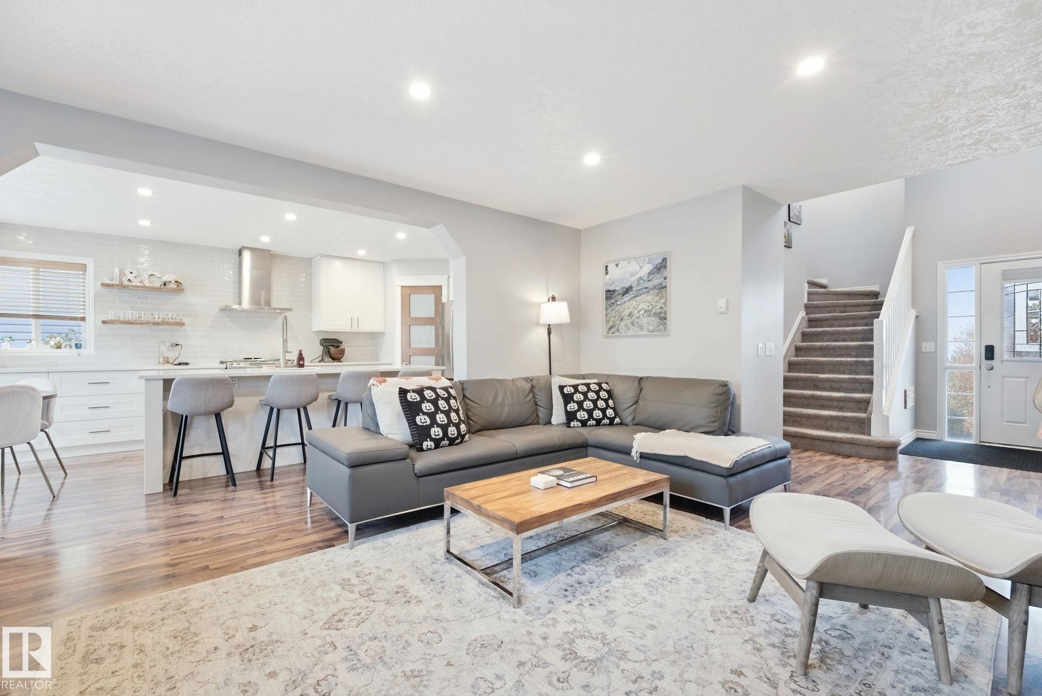 Open-concept living area with wood-finish flooring, recessed lighting, and a neutral color palette - 324 Ascott Crescent, Sherwood Park, AB