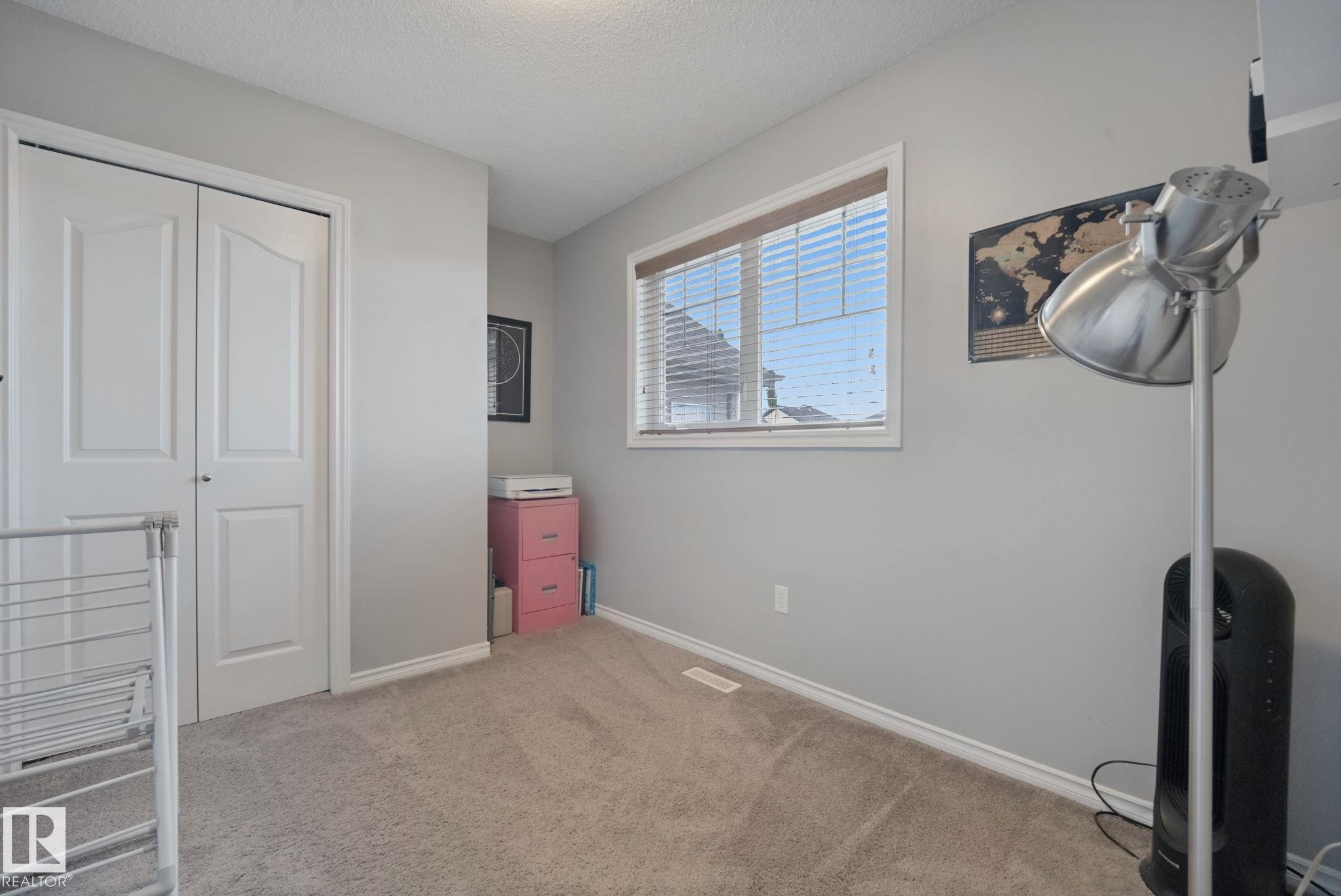 Wall-to-wall carpeting, window with horizontal blinds, and a built-in closet with bi-fold doors - 324 Ascott Crescent, Sherwood Park, AB