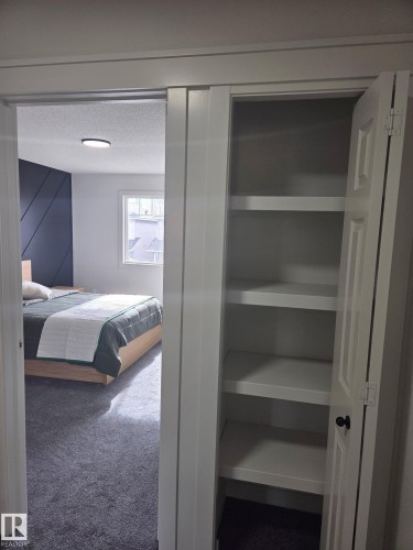Recessed closet with integrated shelving - #27 287 Macewan Rd Sw, Edmonton, AB 