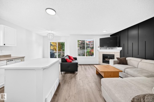 Open-concept living space with wood-finish flooring - #27 287 Macewan Rd Sw, Edmonton, AB 