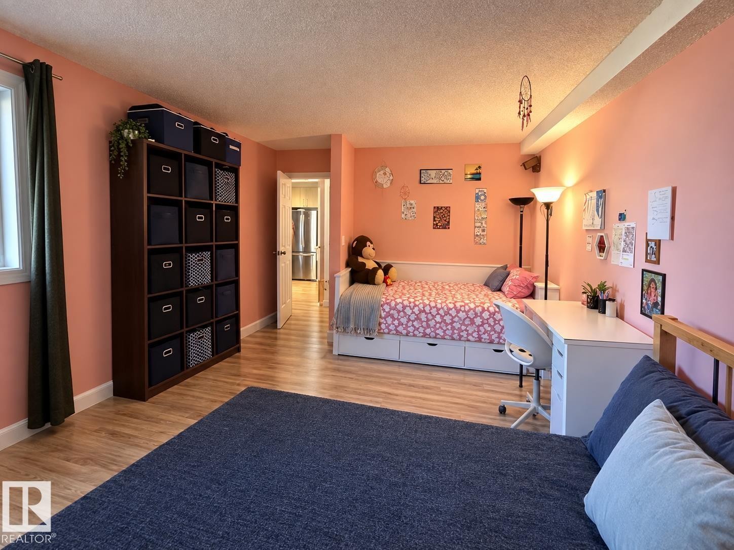 Wood-finish flooring throughout, with a window providing natural light - #108 2624 Mill Woods Rd E Nw, Edmonton, AB