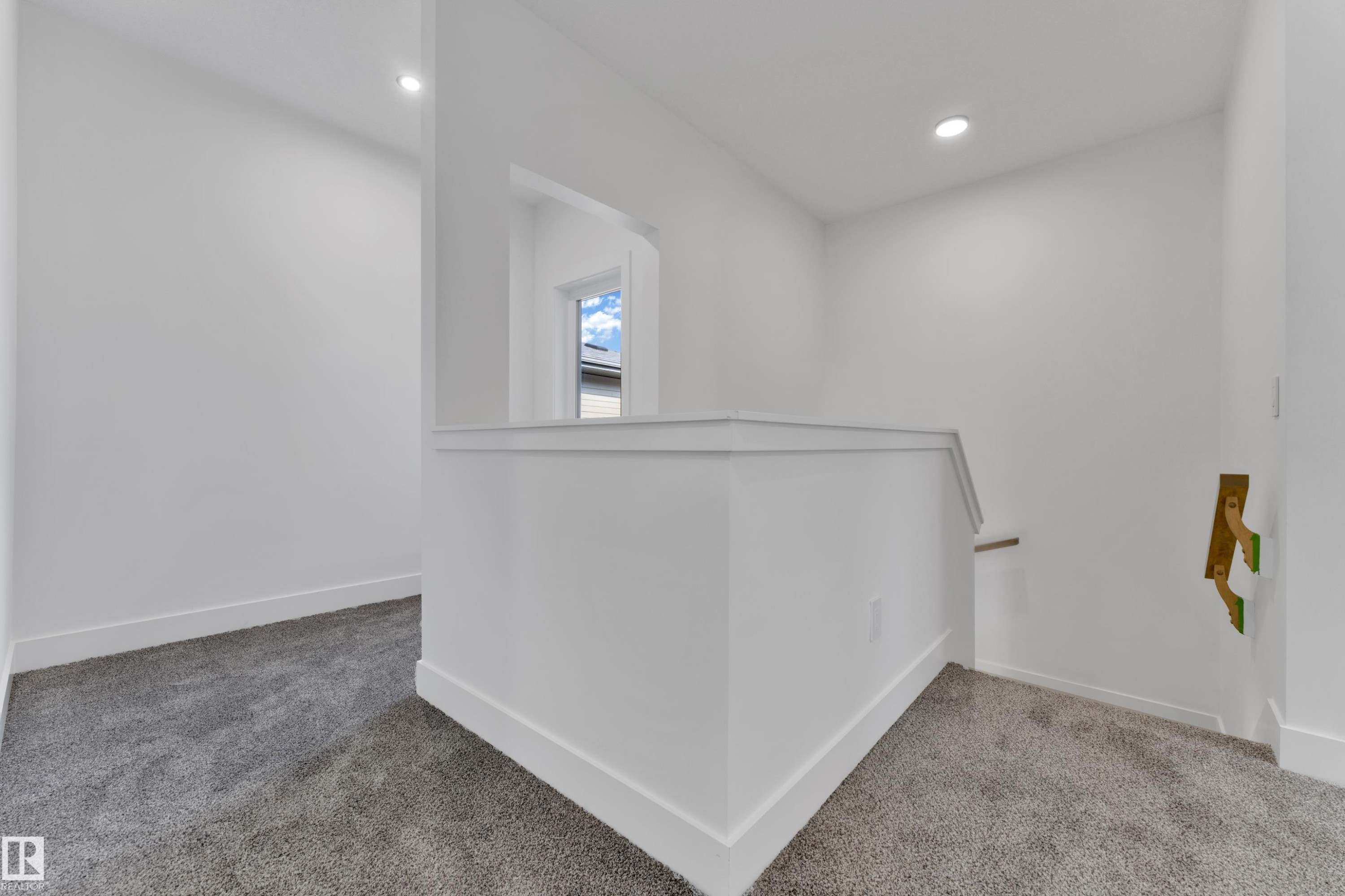 Wall-to-wall carpeting and white walls with recessed lighting - 261 Linden Loop, Leduc, AB