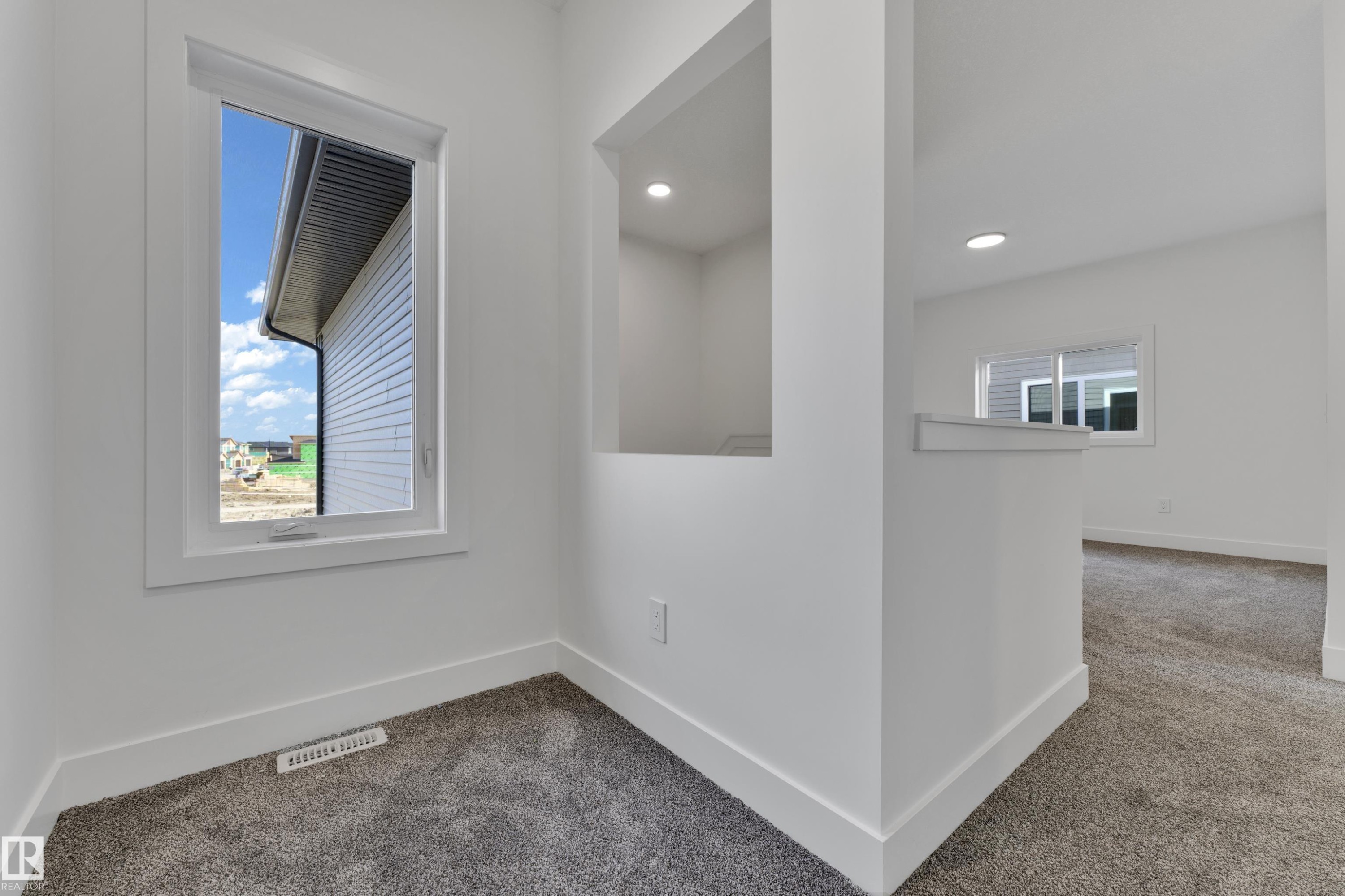 Recessed lighting, wall niche, white trim, white walls, and gray carpeting - 261 Linden Loop, Leduc, AB