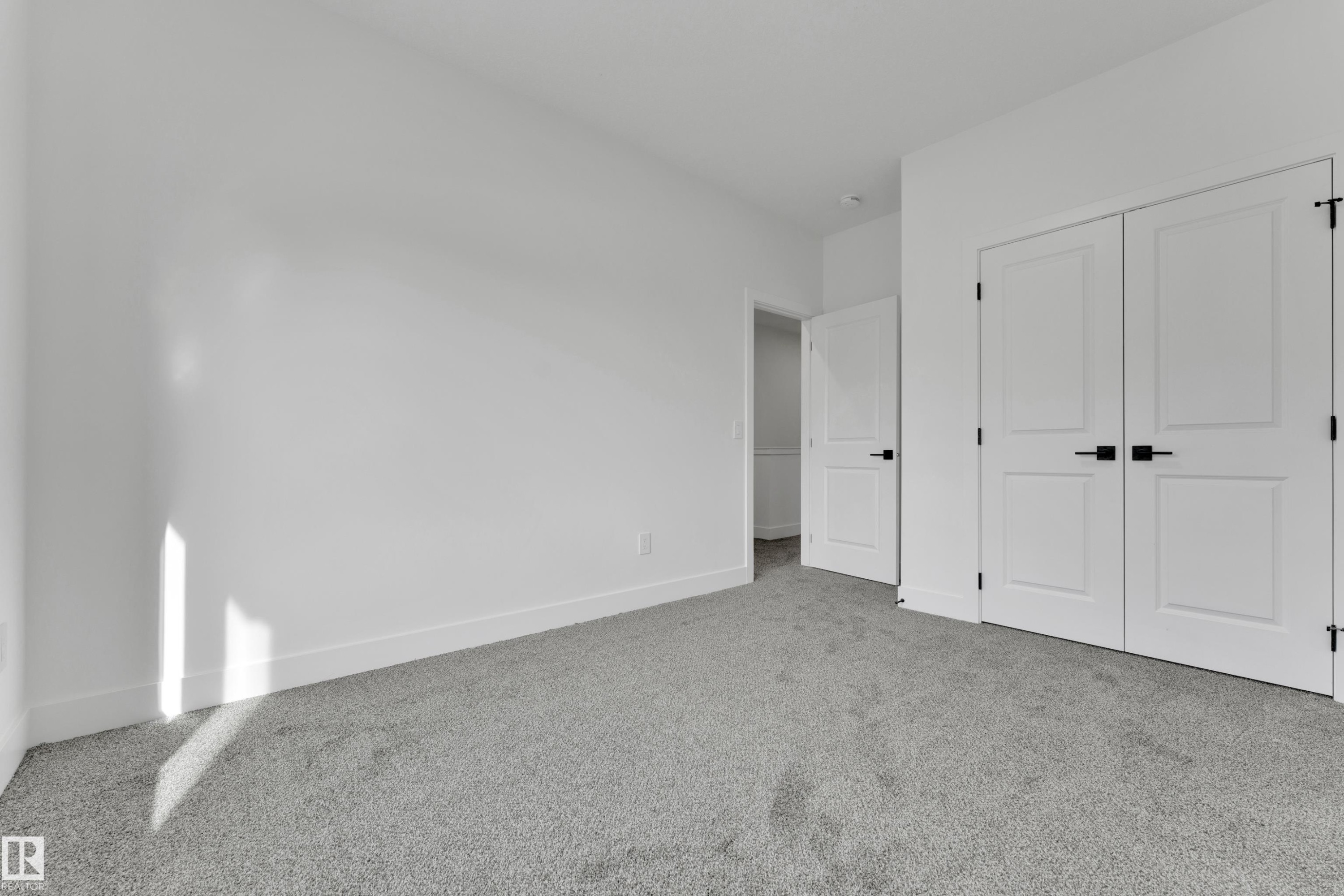 Light gray carpeted flooring, white walls, and white trim - 261 Linden Loop, Leduc, AB