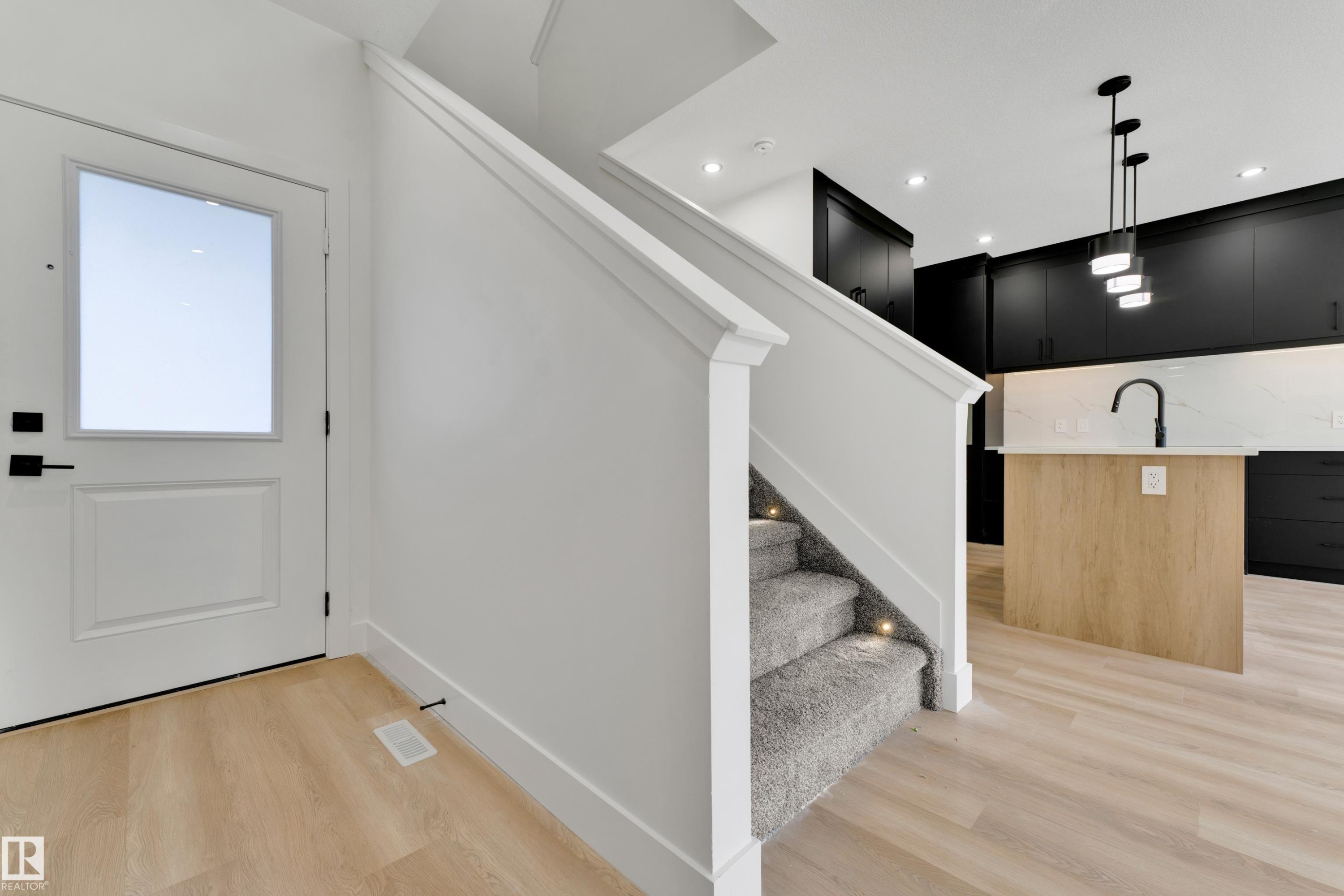 Entry featuring a white panel door with frosted glass - 261 Linden Loop, Leduc, AB
