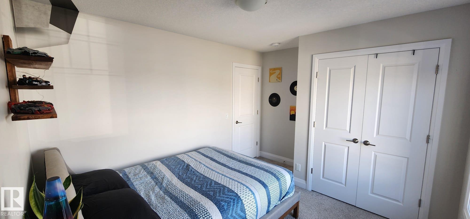 Neutral wall color, wall-to-wall carpeting, recessed ceiling light, ceiling-mounted light fixture, white interior doors - 3779 Cherry Loop Sw, Edmonton, AB